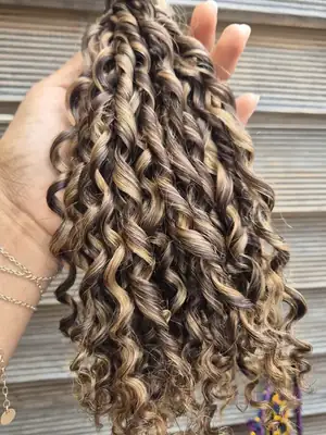 Dark brown pixel curl weave with blonde highlights